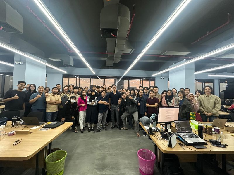 Large group photo of the team standing together in the Jakarta office at the end of the day.